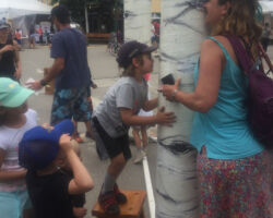 Curious participants explore the aspen eyes at CB Arts Festival.